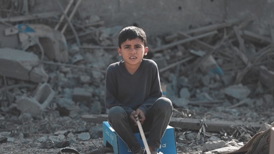 boy sitting in rubble.jpg